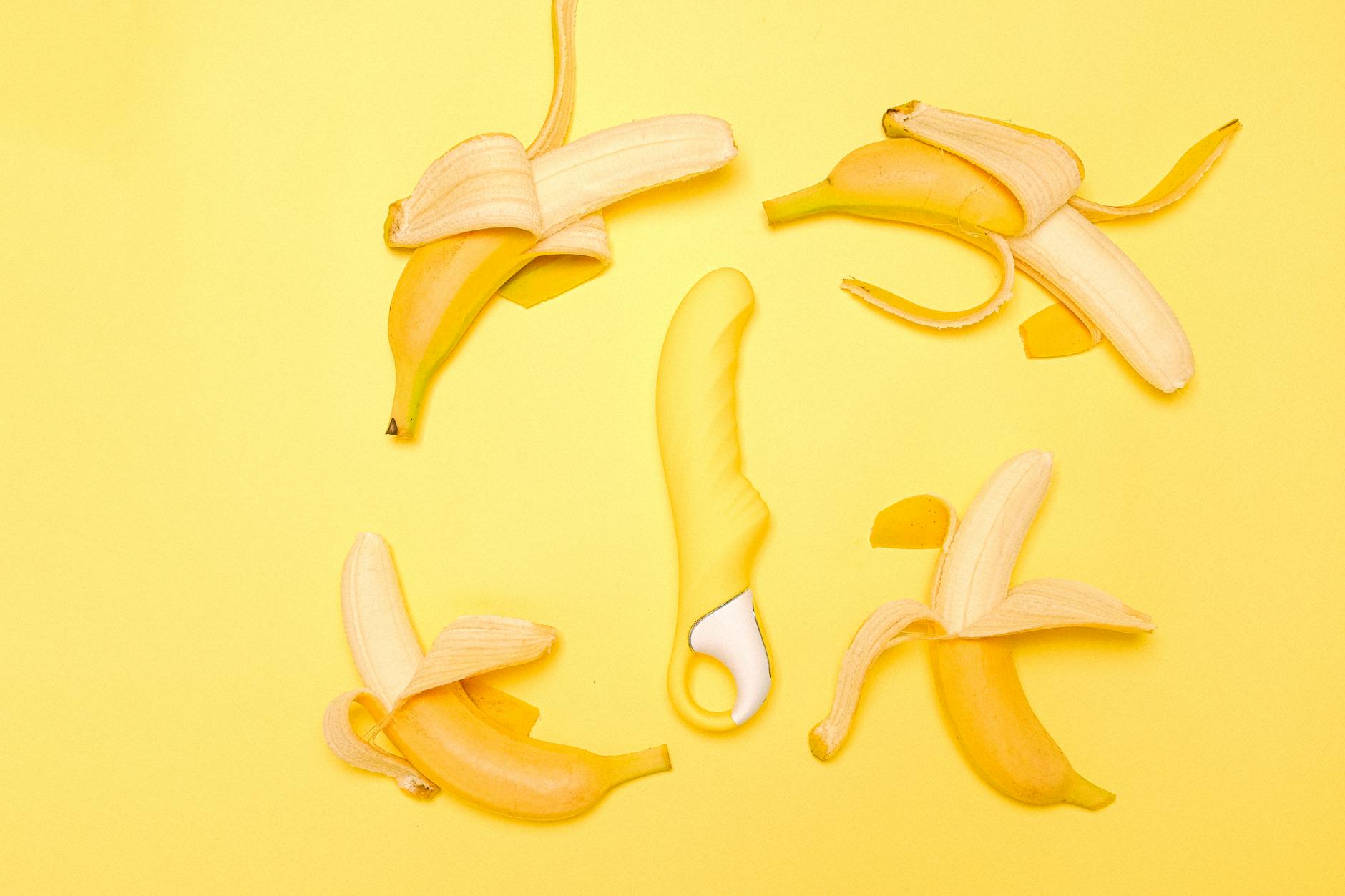 Three colorful clitoral vibrators arranged on white fabric, representing options for couples exploration